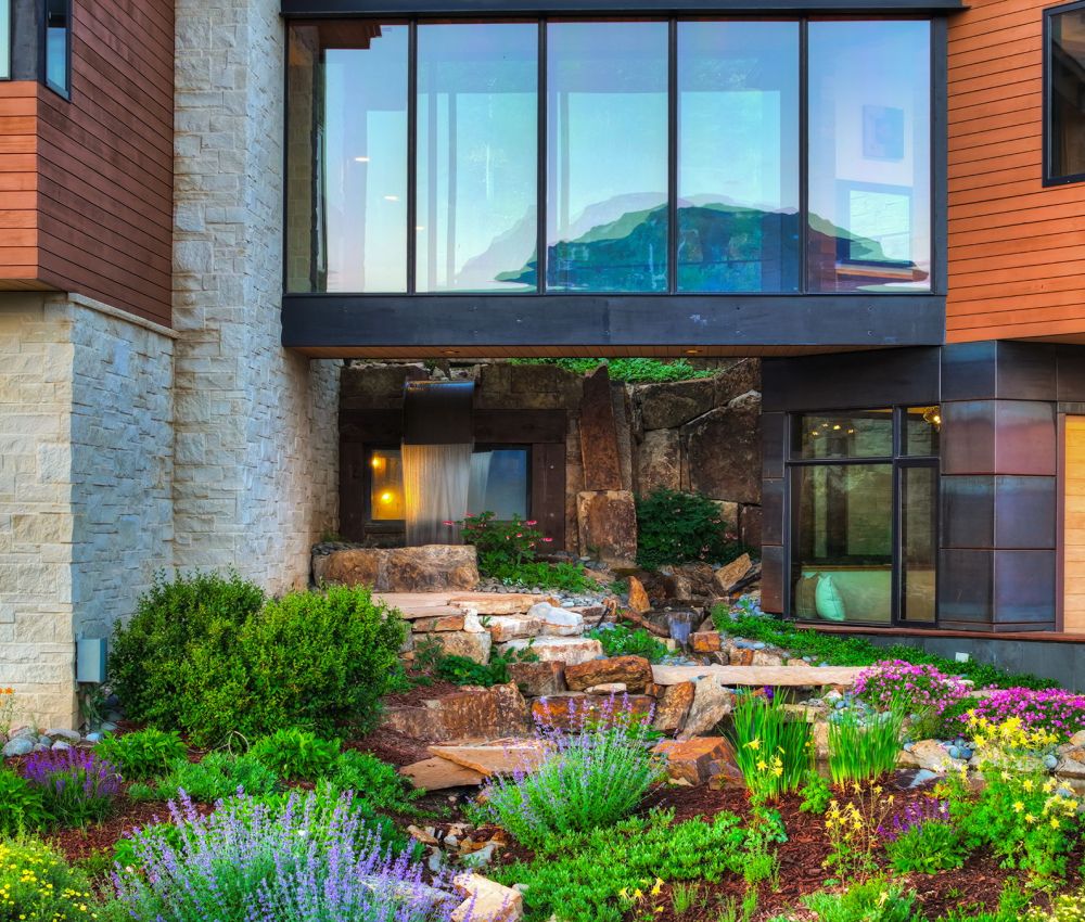 Beautiful custom windows and landscapting make the exterior relaxing.